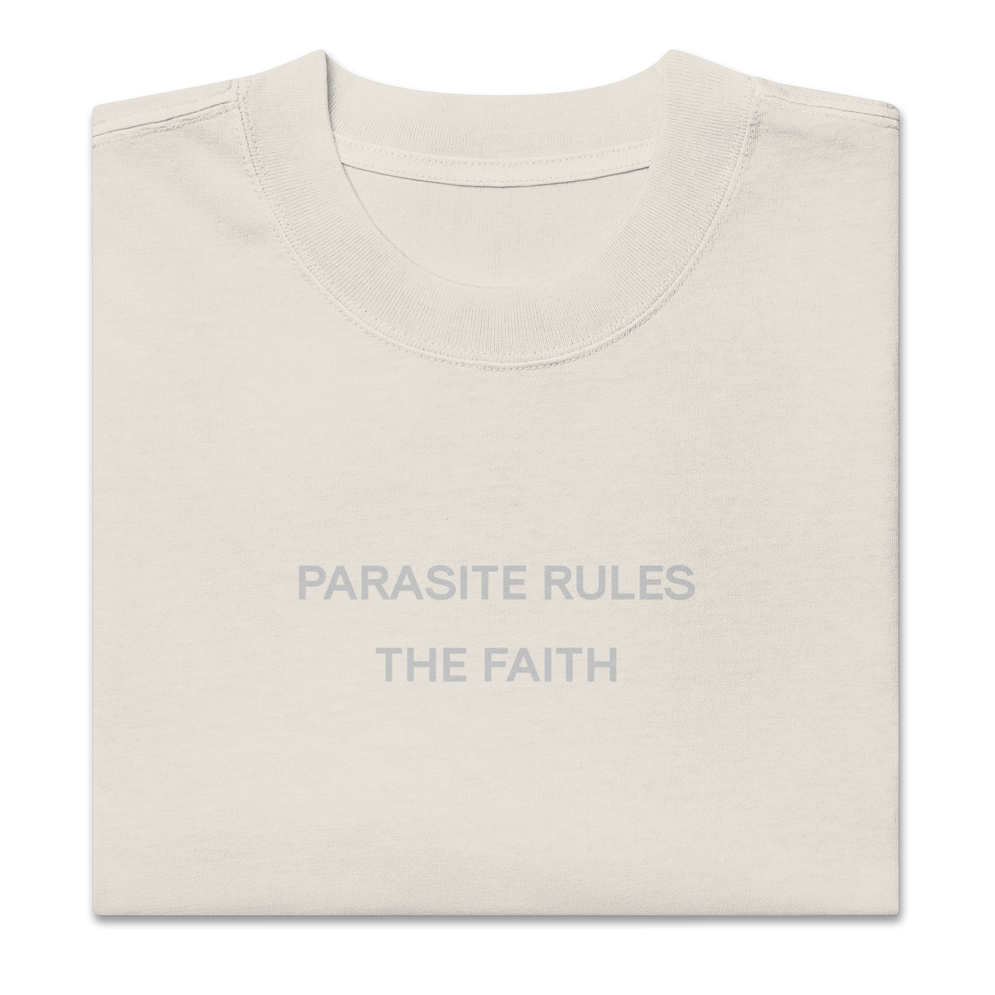 Folded view of NECROBLEND’s oversized unisex T-shirt — signal fragment in faded bone. A softshell of speculative apparel concealing a parasitic invocation.