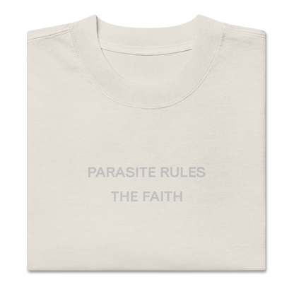 Folded view of NECROBLEND’s oversized unisex T-shirt — signal fragment in faded bone. A softshell of speculative apparel concealing a parasitic invocation.